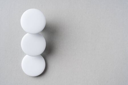Design concept - top view of 3 white badge on grey background for mockup, it's real photo, not 3D renderの写真素材