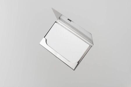 Design concept - top view of horizontal business card with stainless steel case float in the air and isolated on white background for mockup, it's real photo, not 3D renderの写真素材