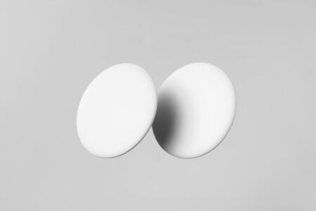 Design concept - top view of 2 white badge float on white background for mockup, it's real photo, not 3D renderの写真素材