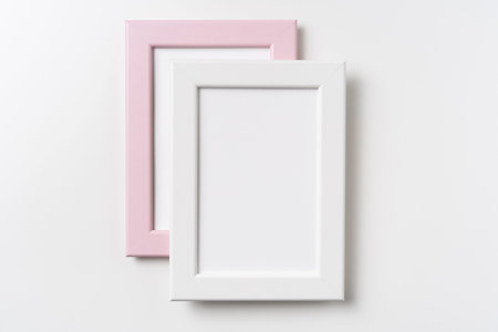 Design concept - top view of two pink and white wood photo frame isolated on white background for...