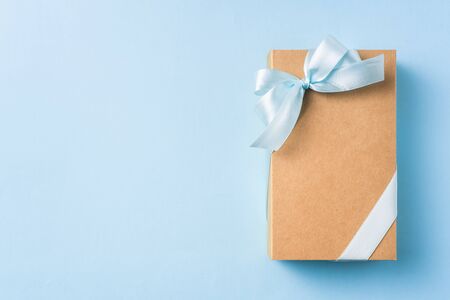 event design concept - top view of fathers day layout with ribbon kraft gift box on blue background, copy space for mock upの写真素材