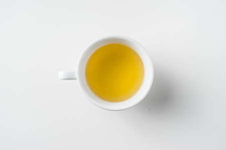 Top view of cup of hot tea on white background desk for mockupの写真素材