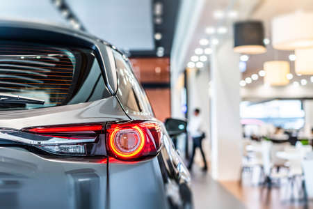 rear view of new modern silver car led tail lights in showroomの写真素材