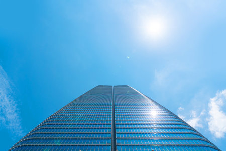 Asia Business concept for real estate, corporate construction and ecology - looking up view of panoramic modern city skyline with blue sky and green tree in Azabudai Hills, tokyo, japanの写真素材