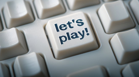 Key Button with the Inscription Lets Playの素材