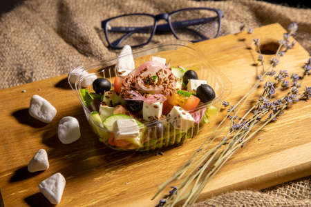 Greek salad in a tray on a boardの写真素材