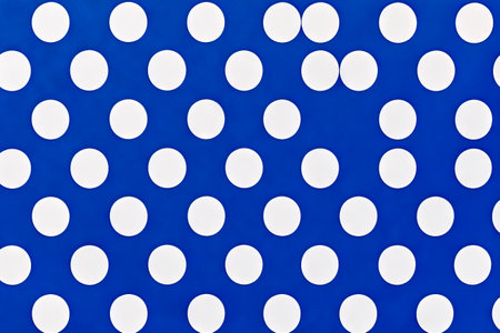 Blue and white polka dot pattern with white circles on it. Generative AI.の素材