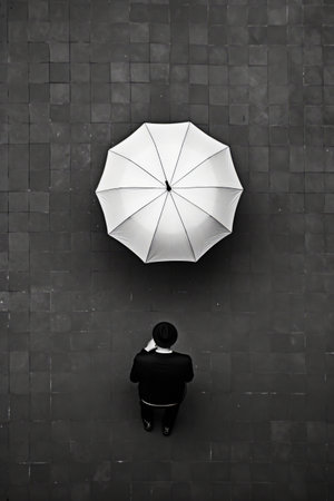 Person standing in front of wall with umbrella. Generative AI.の素材