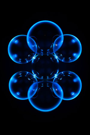 Group of bubbles floating in the air on black background. Generative AI.の素材