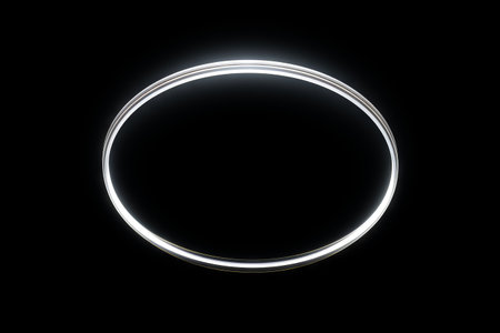 Glowing ring on black background with white light. Generative AI.の素材