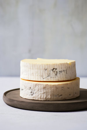 Cheese dish with piece of cheese on top of it. Generative AI.の素材