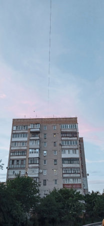 A tall building with a crane attached to it.の写真素材