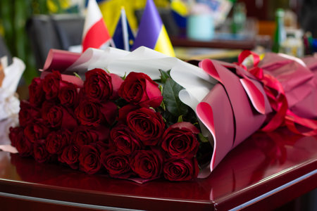 A bunch of red roses sitting on top of a table.の写真素材