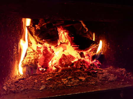 A close up of a fire burning in a fireplace.の写真素材