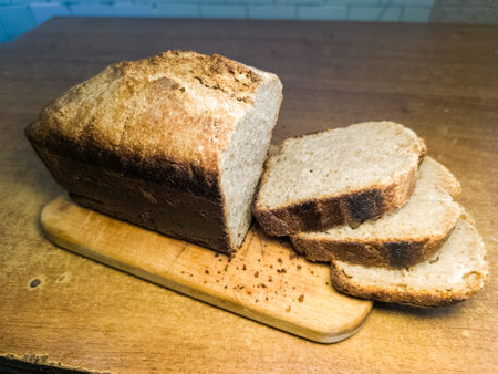 A loaf of bread sitting on top of a wooden board.の写真素材