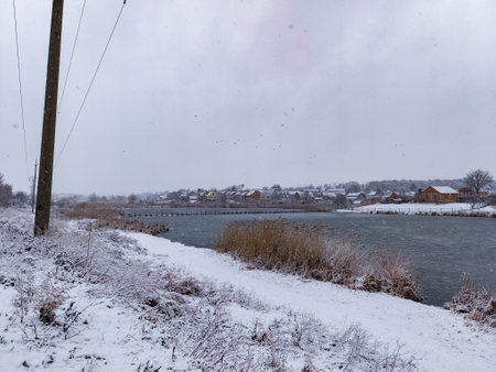 A view of a snowy landscape with a river in the background.の写真素材