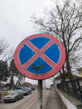 A red and blue sign on the side of a road.の写真素材