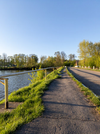 A paved path next to a body of water.の写真素材
