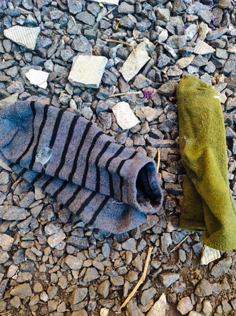 A pair of socks laying on the ground next to each other.の写真素材