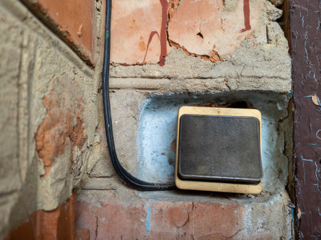 Electric switch with a wire on a brick wall.の写真素材