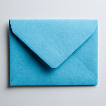 A blue envelope on a white surface.の素材