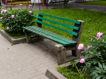 A green park bench sitting in the middle of a flower garden.の写真素材