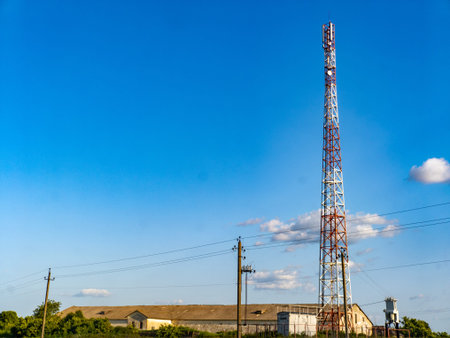 A cell phone tower in the middle of a field.