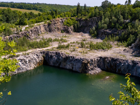 A large body of water surrounded by trees and rocks.の写真素材