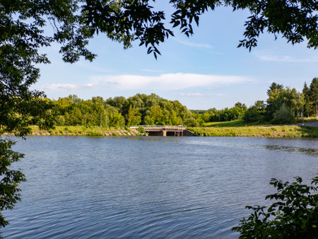 A body of water with a bridge in the background.の写真素材