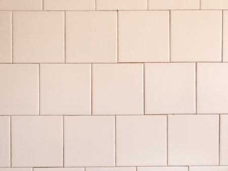 A white tiled wall with a white brick pattern.