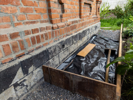 A brick wall with a black tarp covering it next to a brick wall.の写真素材