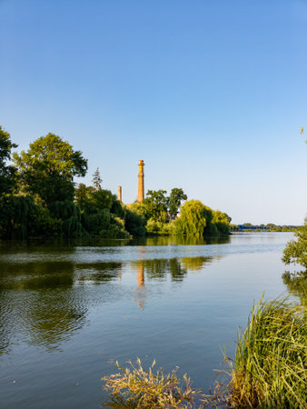 A body of water with a tall tower in the background.の写真素材