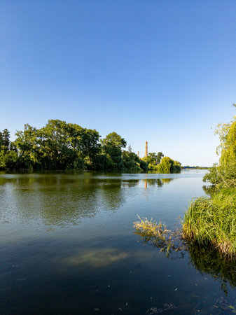A body of water with trees and a tower in the background.の写真素材