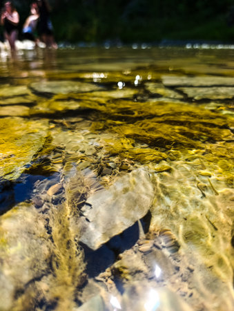 A group of people standing in a body of water.の写真素材