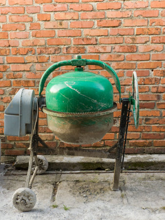A cement mixer sitting on top of a cement mixer stand.