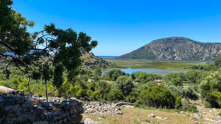 A view of a lake surrounded by trees and mountains.の写真素材