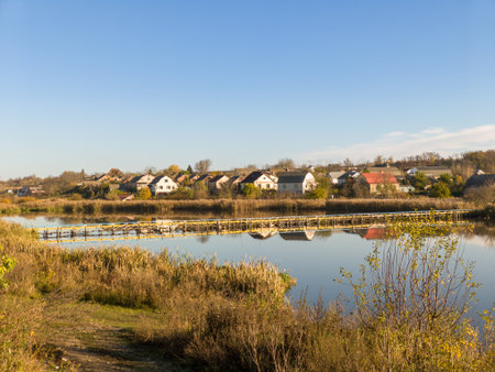 A view of a small town with a bridge over a body of water.の写真素材