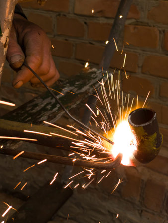 A person is working on a piece of metal with sparks, argon welding.