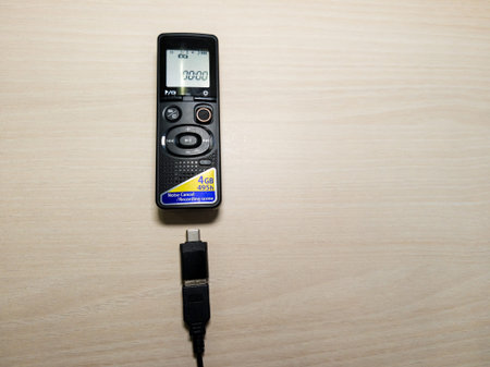 A compact digital voice recorder with a clear display showing 00:00, 4GB storage capacity, and a USB...