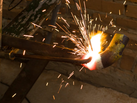 Welder working on a piece of metal with sparks, argon welding.