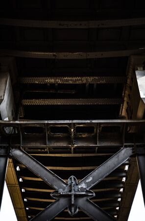 Dark and gloomy industrial atmosphere under the historical rail bridges in Manchester symmetry sun rays day summer blue skyの写真素材