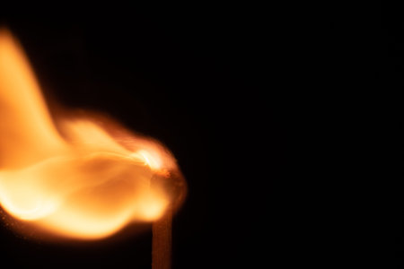 Ignition of match with sparks isolated on black background
