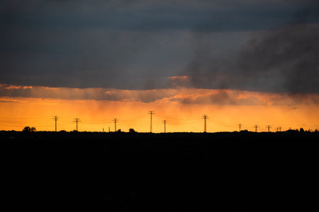 gold sunset and electical wires big field minimalistic clouds smog urban space for text concept...