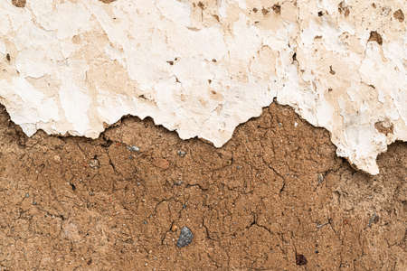Old house wall falling apart texture background orange brown yellow white grunge space for textの写真素材