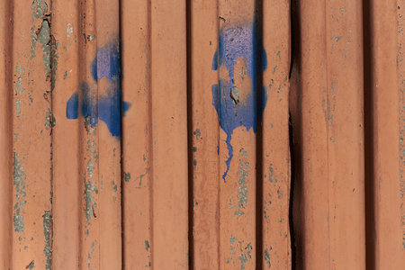 Rusty metal texture wall with smudges scratches and graffiti garage door