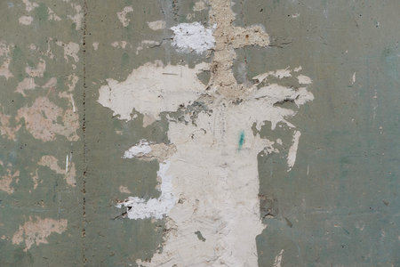 Aged dirty wall with cracks scratches and black brush strokes old abandoned suburban