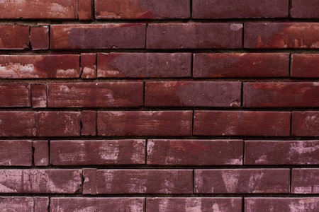 Red painted brick wall background aged vandalism suburban texture