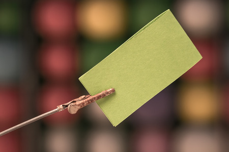Green note pad with rustic clip with colorful backgroundの写真素材