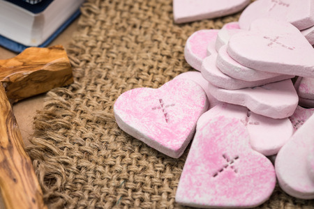 Crafted pink heart shape with cross symbol for religion and love backgroundの写真素材