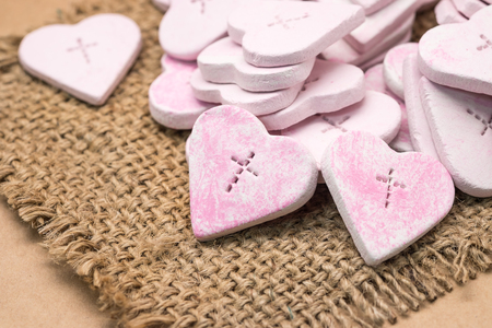 Crafted pink heart shape with cross symbol for religion and love backgroundの写真素材